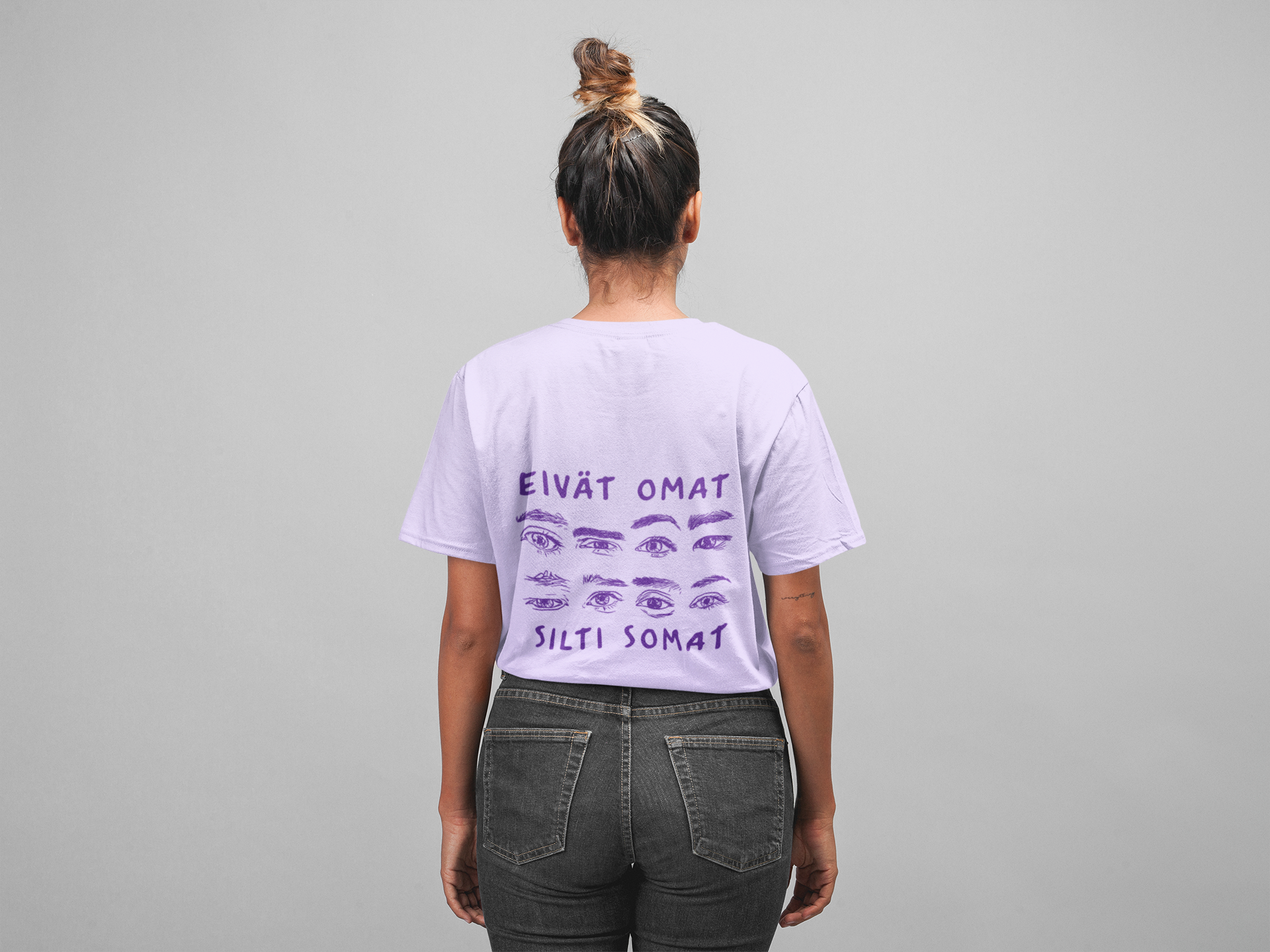 Person wearing a white t-shirt with purple text and graphics on the back, standing against a gray background.